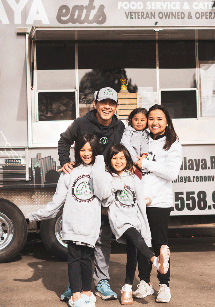 The family behind Malaya Eats' poses in front of their food truck.