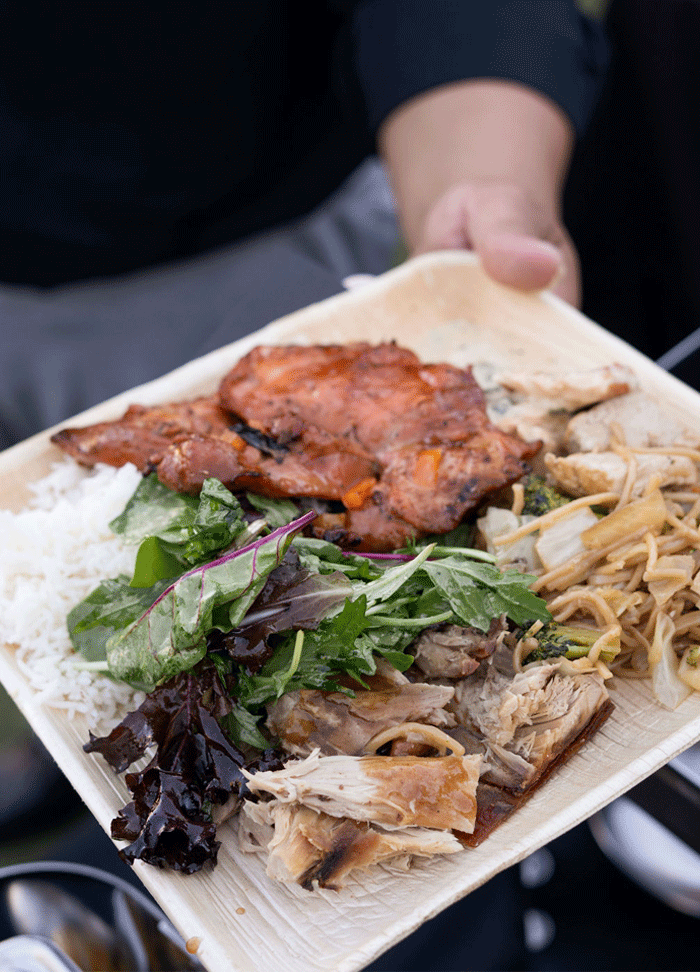 A bamboo plate full of a variety of food.